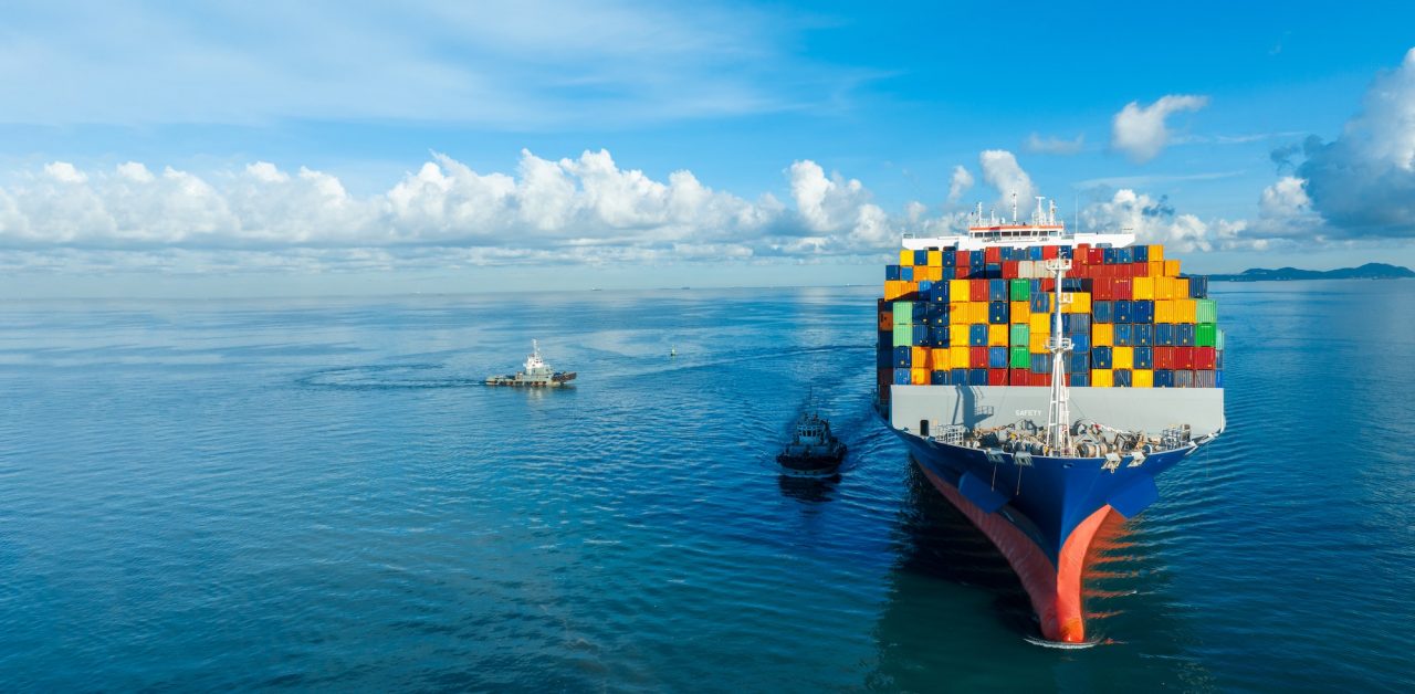 front-view-contaier-cargo-ship-import-export-container-box-on-the-ocean-sea-on-blue-sky.jpg